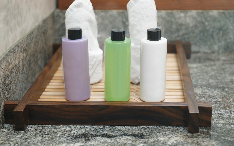 A stock photo of a bottle of shampoo for itchy scalp on a clean bathroom shelf.