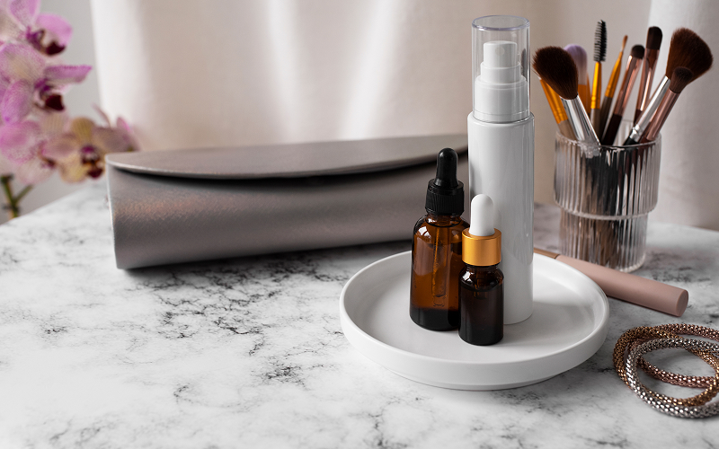 A stock photo of a lash serum bottle on a clean vanity.