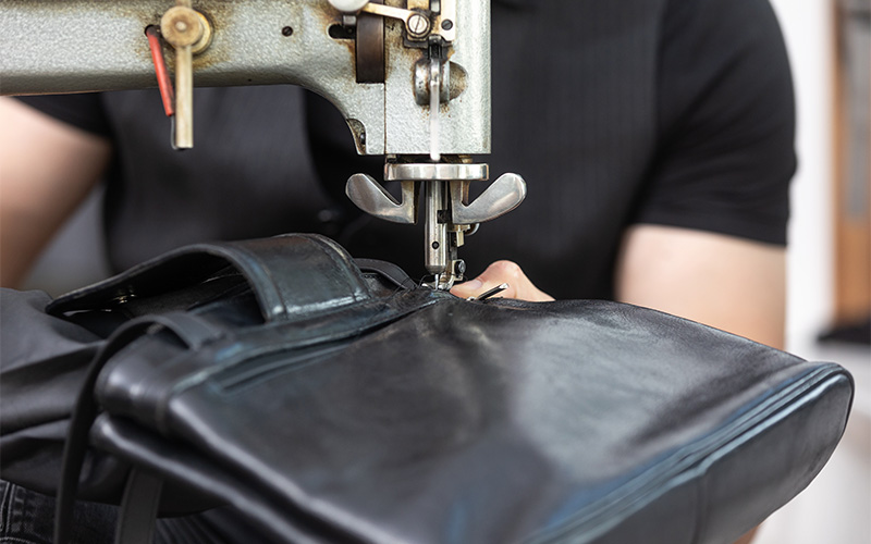 close up of quilted handbag stitching and metal hardware