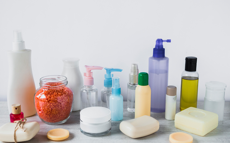cluttered bathroom shelf with too many skincare products