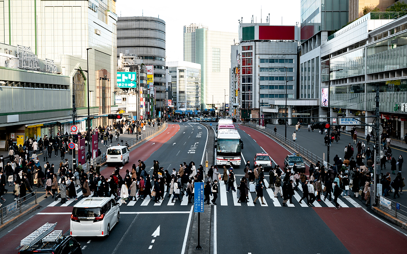 commuter in a busy city, with traffic and buildings in the background