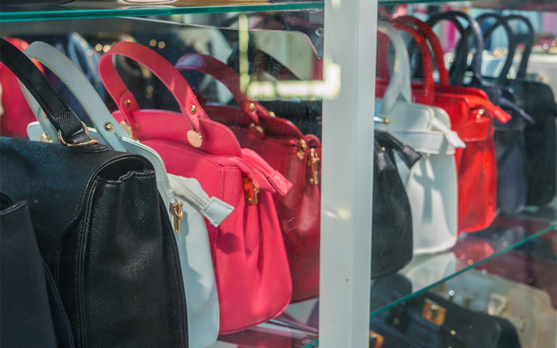 shop window display with an elegant structured handbag