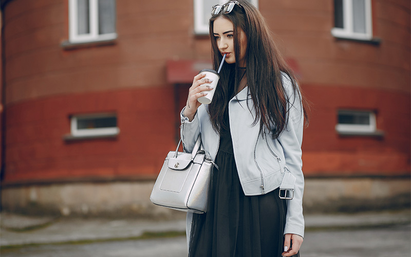 woman carrying a structured handbag